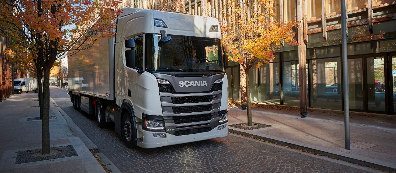 Hvid Scania R 410 på en lille byvej 