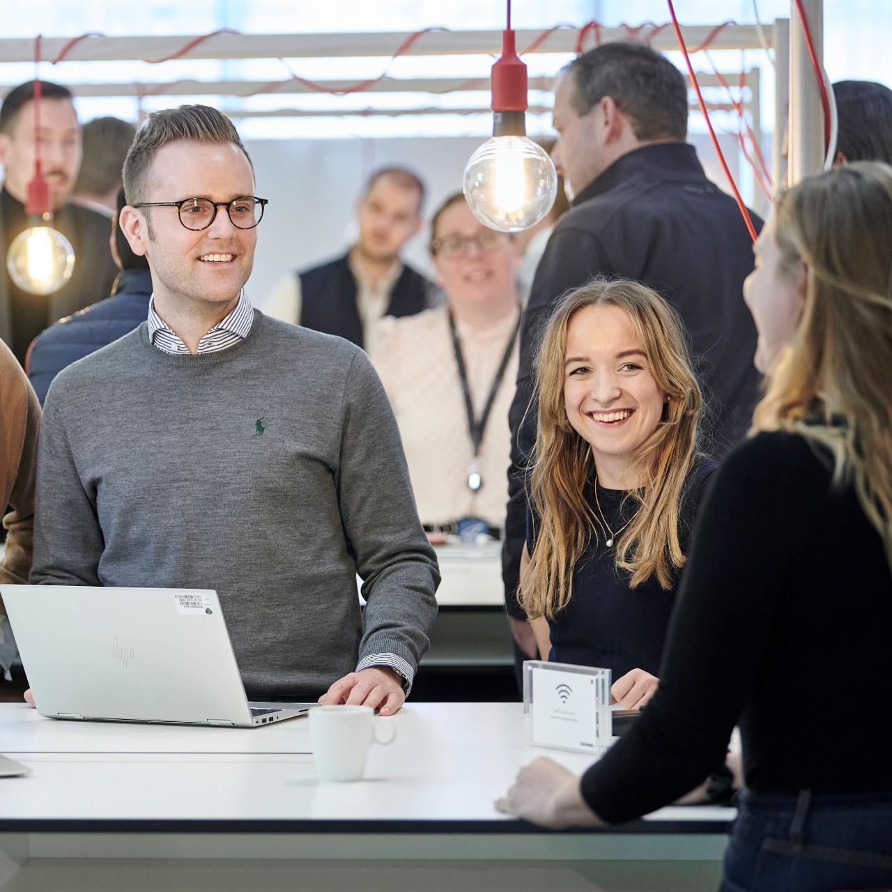 Three Scania employees having a conversation