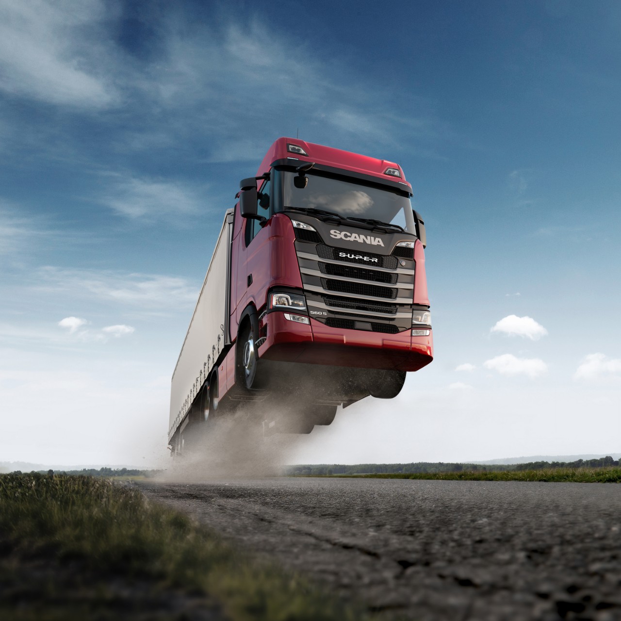 Flygande Scania lastbil i röd färg