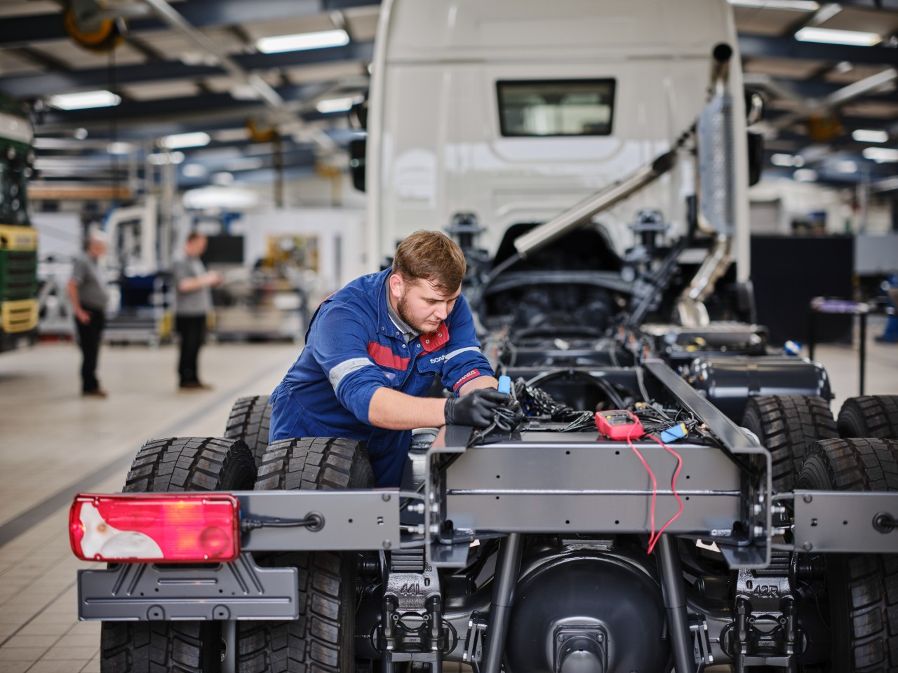 Technician working under a Scania truck